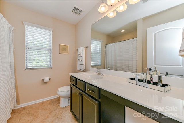 bathroom featuring tile patterned flooring, vanity, and toilet