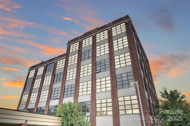 view of outdoor building at dusk