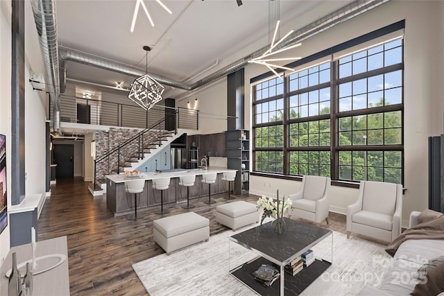 715 N Graham St Unit 201, Charlotte, NC 28202 - living room featuring a high ceiling, an inviting chandelier, and dark hardwood / wood-style floors