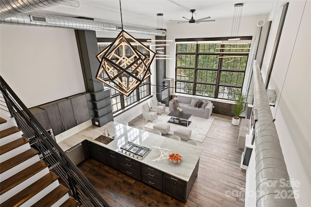 living room featuring ceiling fan and sink