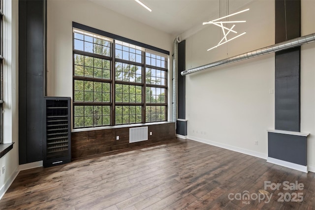 spare room with hardwood / wood-style flooring and wine cooler