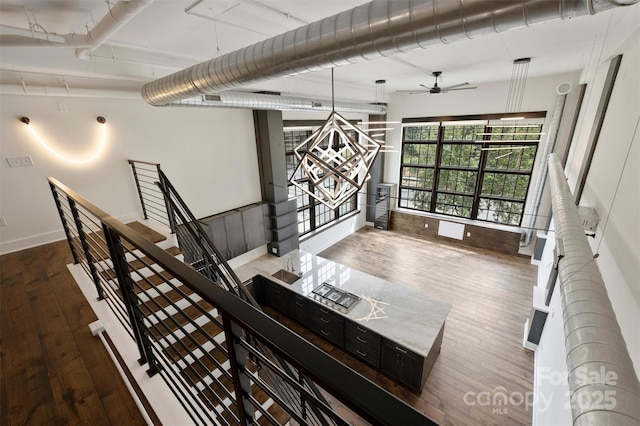 unfurnished living room featuring ceiling fan and wood-type flooring