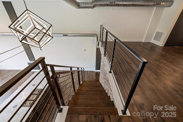 stairs featuring hardwood / wood-style flooring