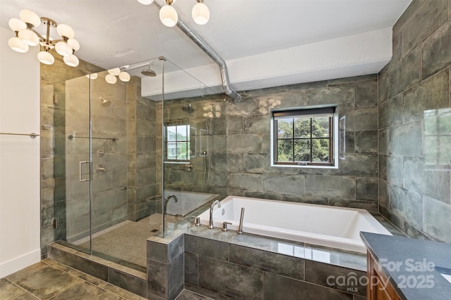 bathroom with vanity, an inviting chandelier, and separate shower and tub