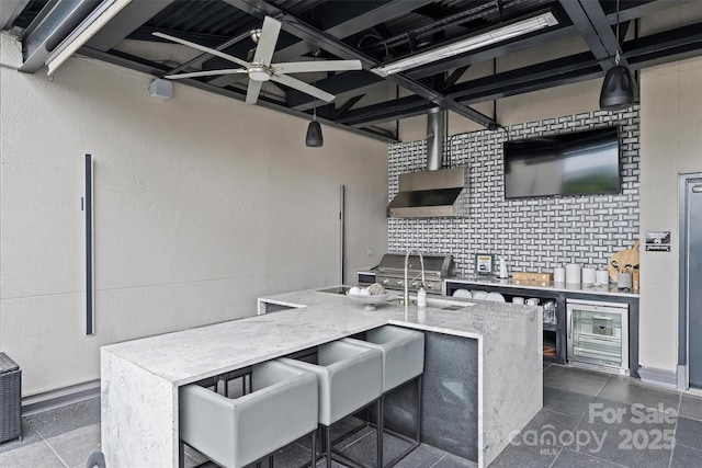 view of patio featuring an outdoor wet bar, grilling area, and ceiling fan