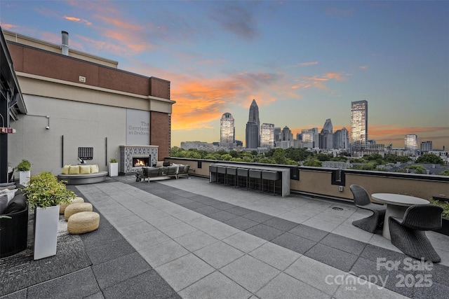 patio terrace at dusk with a tile fireplace