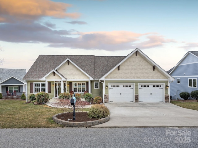 craftsman house featuring a garage, a lawn, and covered porch