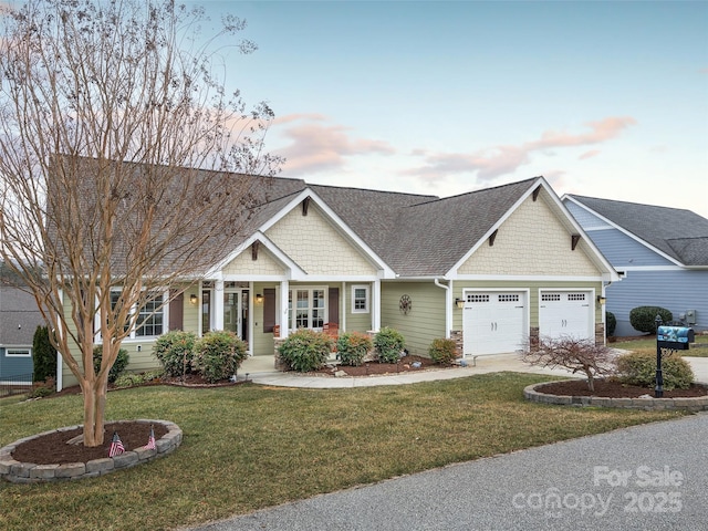 craftsman inspired home featuring a yard and a garage