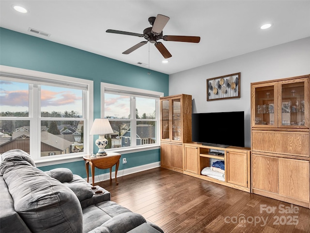 living room featuring dark hardwood / wood-style floors and ceiling fan