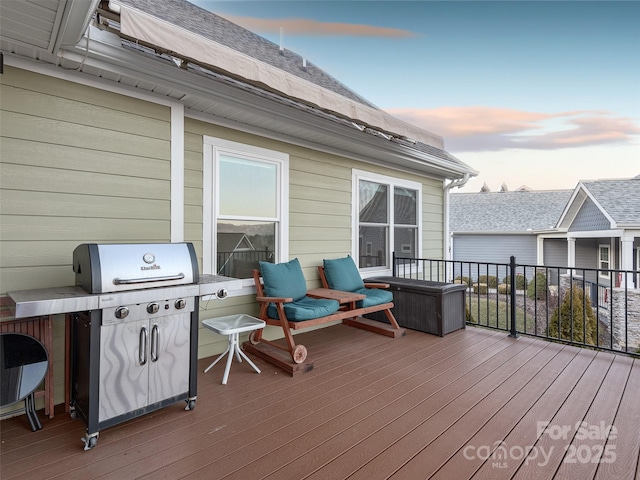 deck at dusk featuring area for grilling