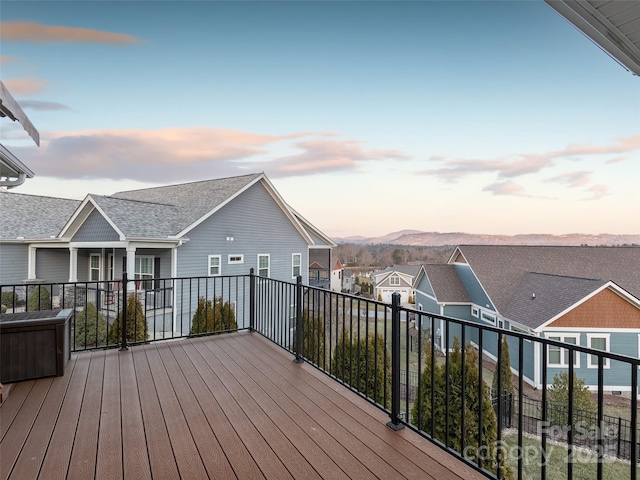 deck at dusk featuring a mountain view