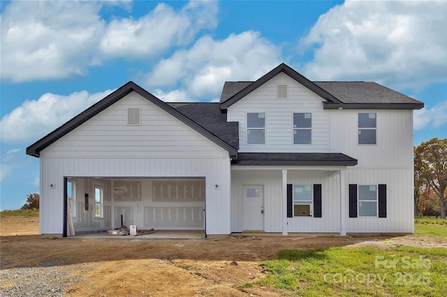 modern inspired farmhouse with a garage