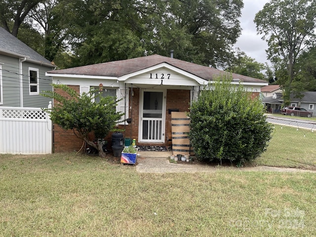 bungalow-style house with a front yard