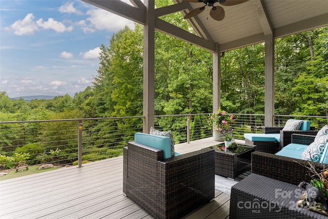 wooden terrace featuring an outdoor living space and ceiling fan