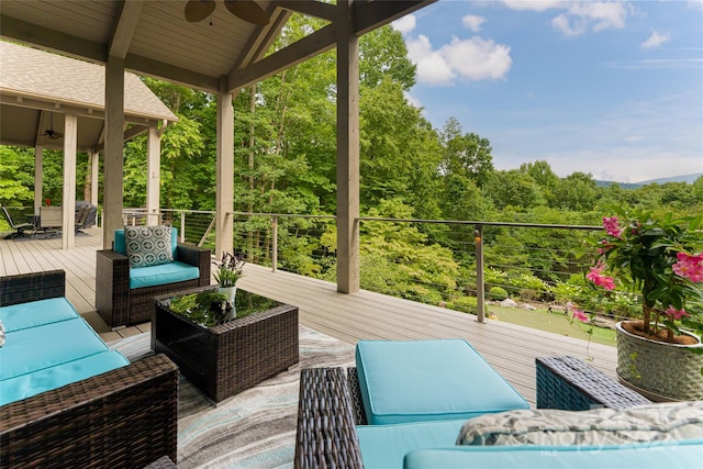 deck with an outdoor hangout area, ceiling fan, and a gazebo