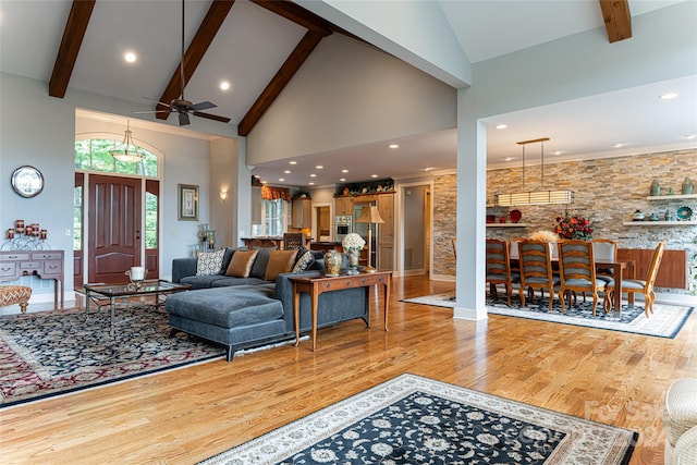 living room with wood-type flooring, beam ceiling, high vaulted ceiling, and ceiling fan