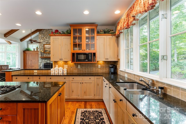 kitchen featuring light wood-type flooring, crown molding, black microwave, and sink