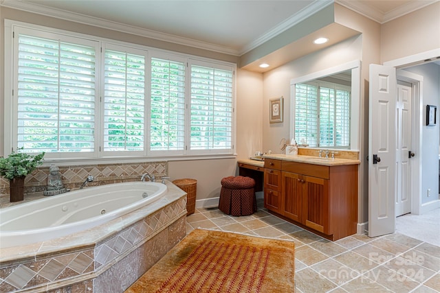 bathroom featuring crown molding, a healthy amount of sunlight, tiled bath, and vanity