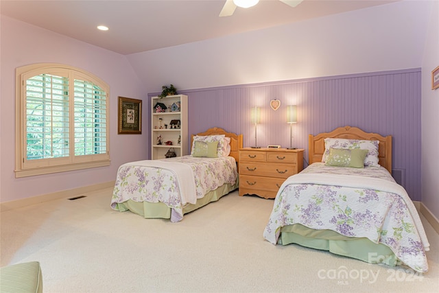 bedroom featuring carpet flooring, vaulted ceiling, and ceiling fan