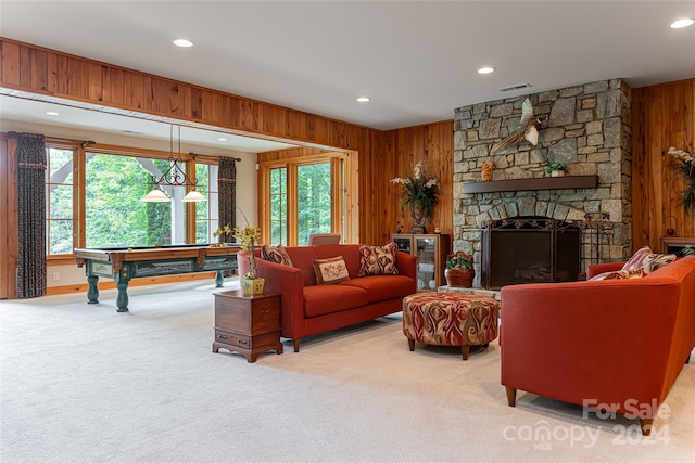 carpeted living room featuring pool table, a fireplace, and wooden walls