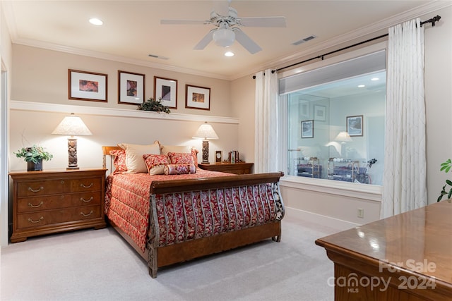 carpeted bedroom with ceiling fan and crown molding