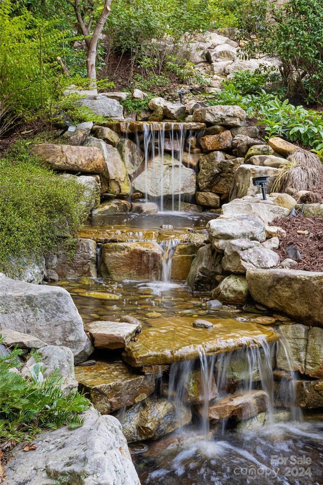 exterior details featuring a garden pond