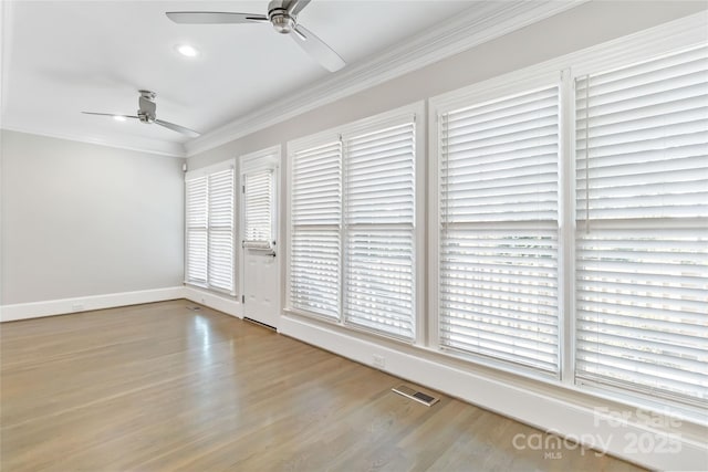 empty room with ceiling fan, ornamental molding, and light hardwood / wood-style flooring