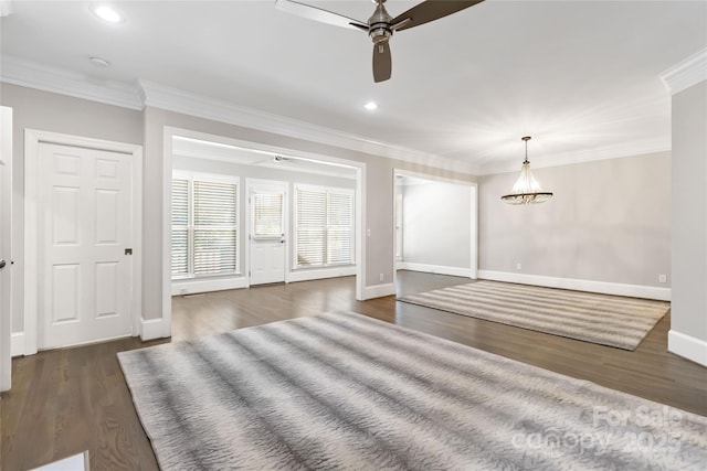 spare room featuring dark hardwood / wood-style flooring, ornamental molding, and ceiling fan