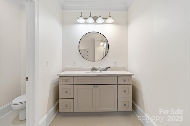 bathroom with crown molding, vanity, and toilet