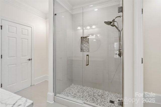 bathroom with an enclosed shower, crown molding, and tile patterned floors