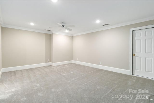 carpeted empty room featuring ornamental molding and ceiling fan