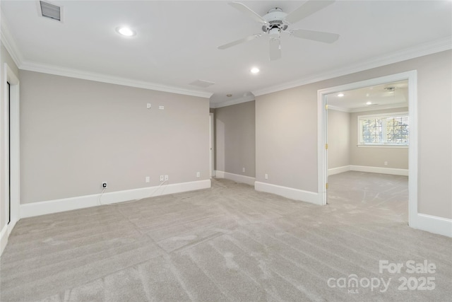 carpeted empty room featuring crown molding and ceiling fan