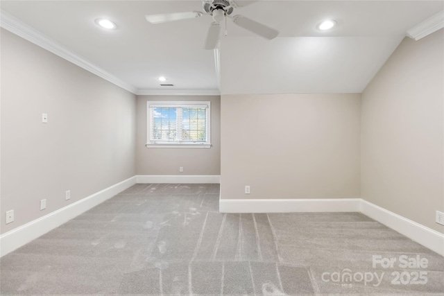 unfurnished room with ceiling fan, light colored carpet, ornamental molding, and lofted ceiling