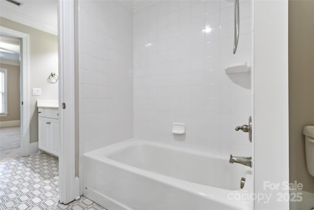 full bathroom featuring ornamental molding, toilet, vanity, and tiled shower / bath