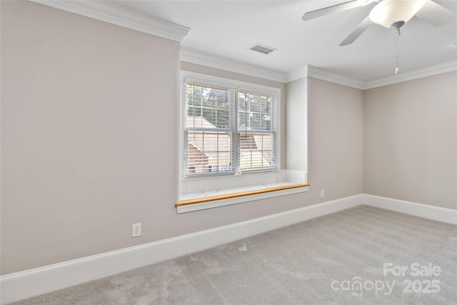 spare room featuring light carpet, crown molding, and ceiling fan