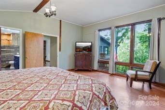 bedroom featuring lofted ceiling, ornamental molding, hardwood / wood-style flooring, and ceiling fan with notable chandelier