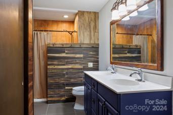 bathroom featuring toilet, vanity, and tile patterned flooring