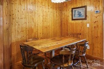 dining room with wooden walls