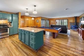 kitchen with pool table, hanging light fixtures, stainless steel range oven, and light wood-type flooring