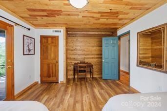 bedroom featuring wood ceiling and hardwood / wood-style flooring