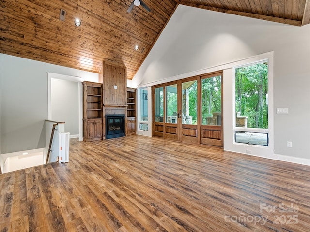 unfurnished living room featuring ceiling fan, a fireplace, high vaulted ceiling, and hardwood / wood-style floors