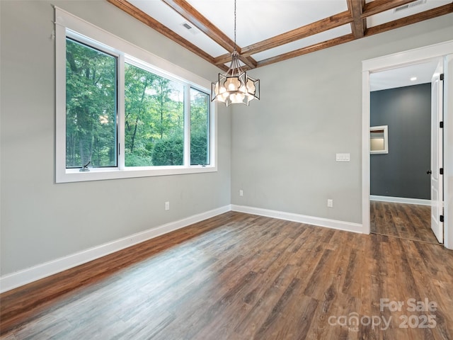 spare room with dark wood-type flooring, beamed ceiling, a chandelier, and coffered ceiling