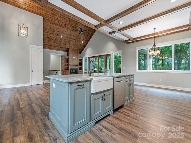 kitchen with dishwasher, light stone counters, an island with sink, and hanging light fixtures