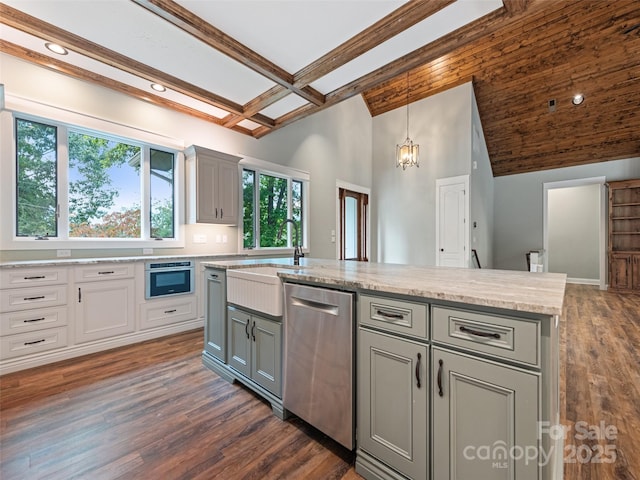 kitchen featuring appliances with stainless steel finishes, decorative light fixtures, beamed ceiling, a center island, and gray cabinets