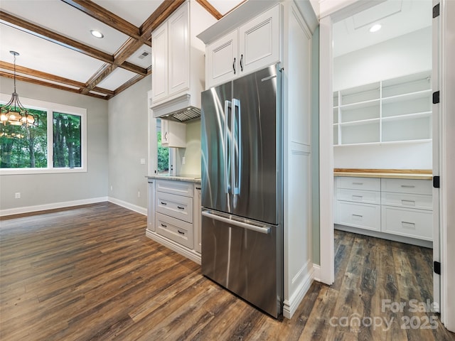 kitchen featuring stainless steel fridge, white cabinetry, beam ceiling, and coffered ceiling