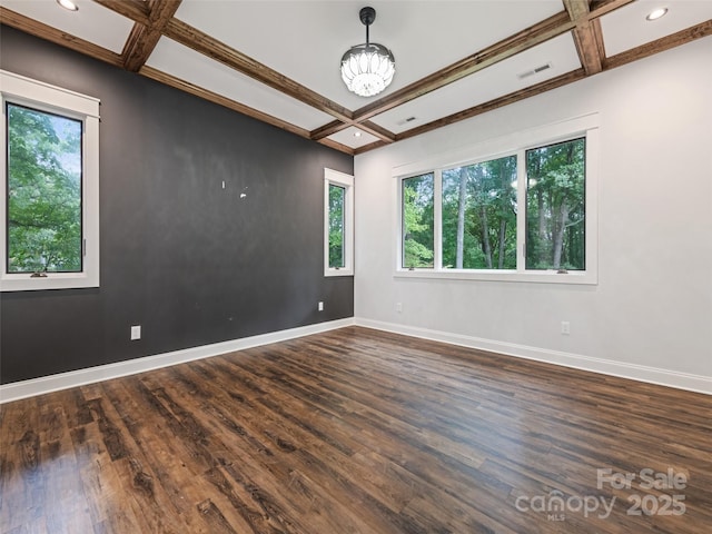 unfurnished room featuring plenty of natural light, dark hardwood / wood-style flooring, and coffered ceiling