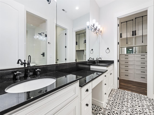 bathroom featuring tile patterned flooring, vanity, and a shower with shower door