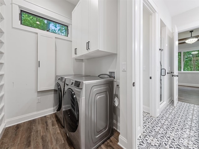 washroom featuring cabinets and independent washer and dryer