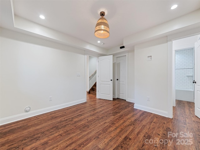 unfurnished bedroom with dark wood-type flooring