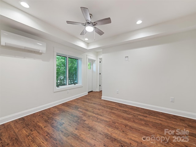 unfurnished room featuring a wall mounted AC, ceiling fan, and dark hardwood / wood-style floors